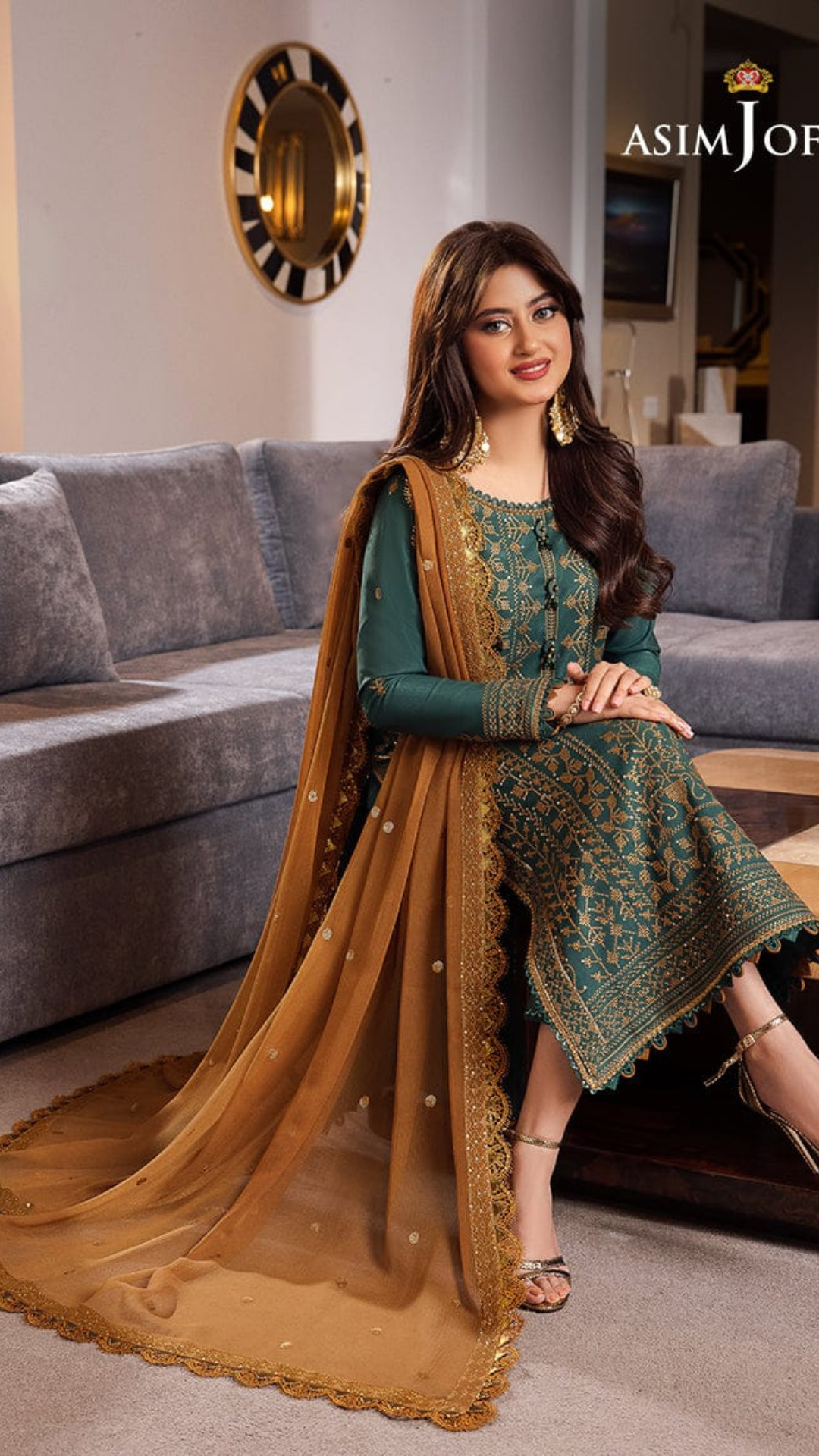 Asma Johar collection display featuring a variety of elegant garments and accessories in a stylish setting.