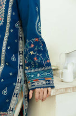  A woman models a blue and white embroidered dress, highlighting its detailed craftsmanship and stylish appearance.