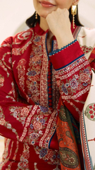 A woman wearing red and white clothing smiles and poses for the camera.